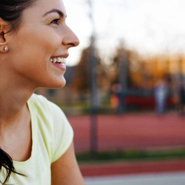Beautiful sporty female jogger tired after running